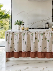 Close-up of linen cabinet curtain with cactus embroidery and brown ruffle hem