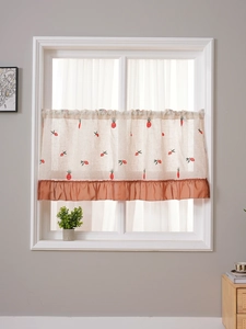 Detailed embroidery of red pineapple patterns on linen cafe curtain with ruffled trim