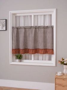 Detail of coffee curtain with brown checkered pattern and elegant ruffled edge trim