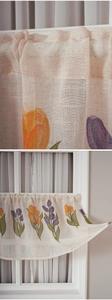 Close-up detail of textured linen cafe curtain with purple and orange tulip floral prints