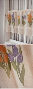 Detail of tulip printed linen cafe curtain showing the fabric texture and floral pattern