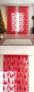 Detail of red Christmas lace curtain with embroidered reindeer and festive holiday patterns