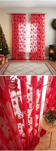 Detailed view of red Christmas lace curtains with festive reindeer and tree embroidery