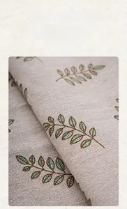 Detail of dark green vintage leaf pattern on thick cotton linen fabric texture