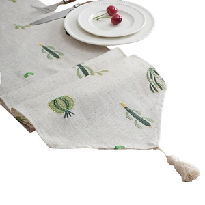 Linen table runner with green cactus embroidery and decorative tassels for home decor