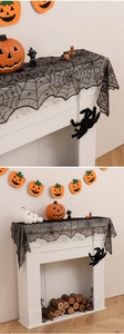 Detail of black lace spider web runner with intricate textures for Halloween decor
