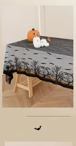 Detail of Halloween black lace tablecloth with bat silhouettes and spooky tree patterns