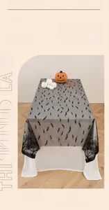 Detailed texture of black lace Halloween tablecloth featuring dense bat patterns