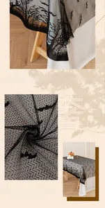 Macro detail of Halloween black lace tablecloth featuring bat and dry tree silhouettes