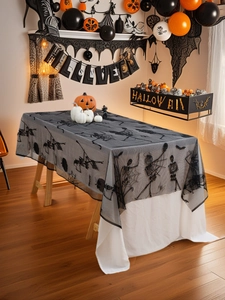 Detailed view of Halloween black lace tablecloth with skull spider web and bat patterns