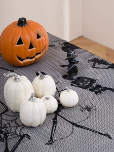 Detail of Halloween black lace tablecloth with spider web and skull patterns