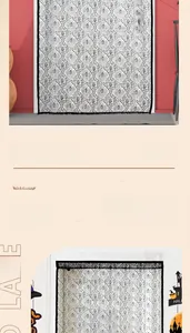 Detail showing white lace door curtain with black bat patterns for Halloween decor