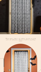 Detail of Halloween door curtain with black palm and spider web lace patterns