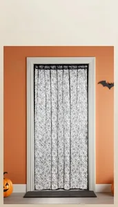 Close-up of black lace Halloween door curtain featuring intricate spider web patterns