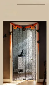 Close-up of black Halloween door curtain with intricate spider web lace pattern