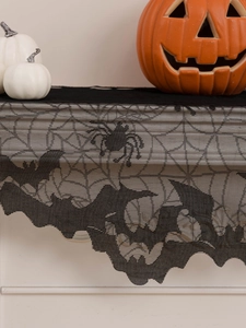 Detail of Halloween black lace fireplace scarf with spider and bat knit patterns