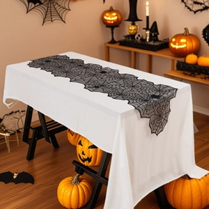 Halloween black lace spider web table runner set against a festive pumpkin background