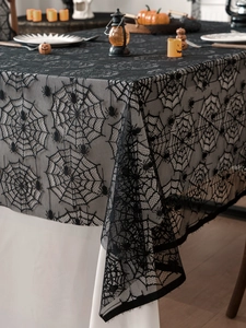 Close-up of black lace spider web tablecloth for Halloween party table decoration