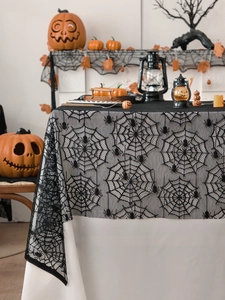 Detailed texture of black lace spider web tablecloth for Halloween party home decoration