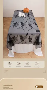 Detail of Halloween lace tablecloth featuring black spider web and skull flocking pattern