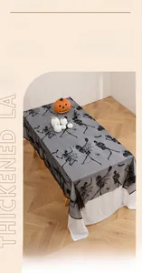 Close-up of thickened black lace Halloween tablecloth with skeleton and spider web patterns