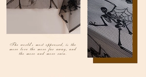 Close-up of Halloween table runner with black skull and spider web prints on woven fabric