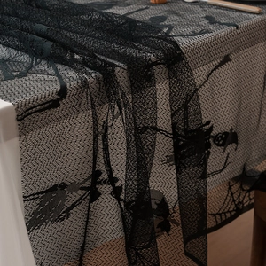 Halloween black lace tablecloth featuring skull and spider web patterns for party decor