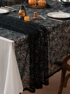 Close-up of black lace spider web tablecloth for Halloween party table decoration