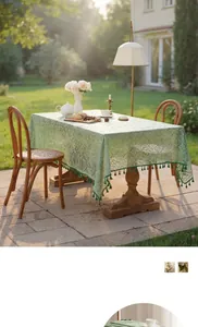 Detail of light green French lace tablecloth with hollow patterns and tassel edges