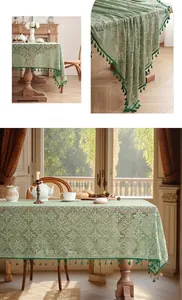 Detail of sage green lace tablecloth featuring hollow crochet patterns and dark green tassels