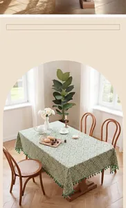 Detail of light green French lace tablecloth with textured jacquard and green tassels