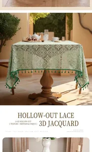 Detail of light green hollow lace tablecloth with floral jacquard and fringe edges