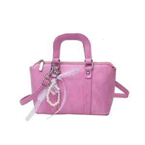 Pink lychee texture bow pillow bag with pearl ribbon pendant for women in 2025 style