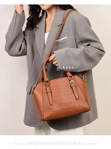 Brown crocodile pattern tote bag shown on a model wearing an oversized grey blazer