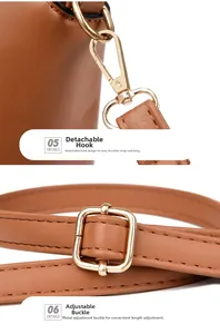 Close-up of golden metal hooks and adjustable strap on a brown lychee pattern handbag
