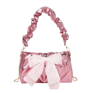 Metalen roze geplooide schoudertas met grote witte strik en gouden ketting riem