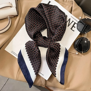 Elegant silk-like scarf with red circular geometric patterns on black base and blue borders