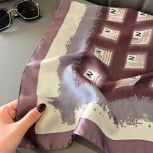 Detailed view of square silk-like scarf with Z-letter pattern and elegant color splicing