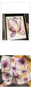 Detail of silk square scarf featuring retro floral patterns in lavender and purple