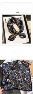 Gros plan d'un foulard en soie bleu marine à motifs floraux orange et texture soyeuse