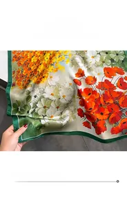 Detail of green hemmed edges and floral print on premium silk square scarf