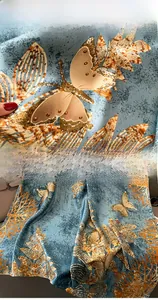 Detail of silk scarf showing vibrant butterfly print and meticulous hemmed edge finish