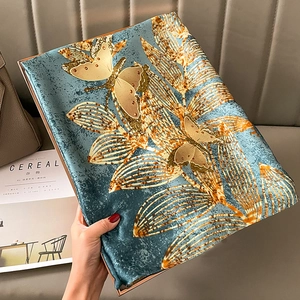 Elegant silk scarf with golden butterfly patterns and leaf texture in grey-blue