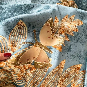 Silk satin scarf with golden butterfly and leaf print on greyish blue background