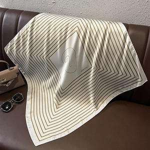 Elegant striped square scarf with geometric patterns and Heartfelt text on leather sofa