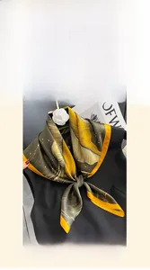 Detail of 70x70cm mulberry silk square scarf featuring olive green leaf patterns