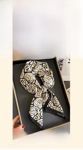 Detailed view of 70x70cm mulberry silk square scarf with golden camellia flower patterns