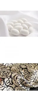 Macro shot of natural silk cocoons and black white camellia patterned crepe satin silk