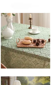 Detail of French vintage light green lace tablecloth with hollow knit floral pattern