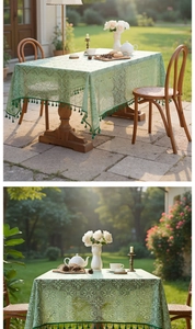 Detail view of light green lace tablecloth with dark green tassels in vintage style